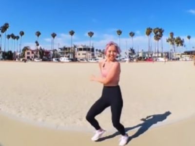 The Nike sneaker is in all white as Bailey Sok is dancing in the beach.